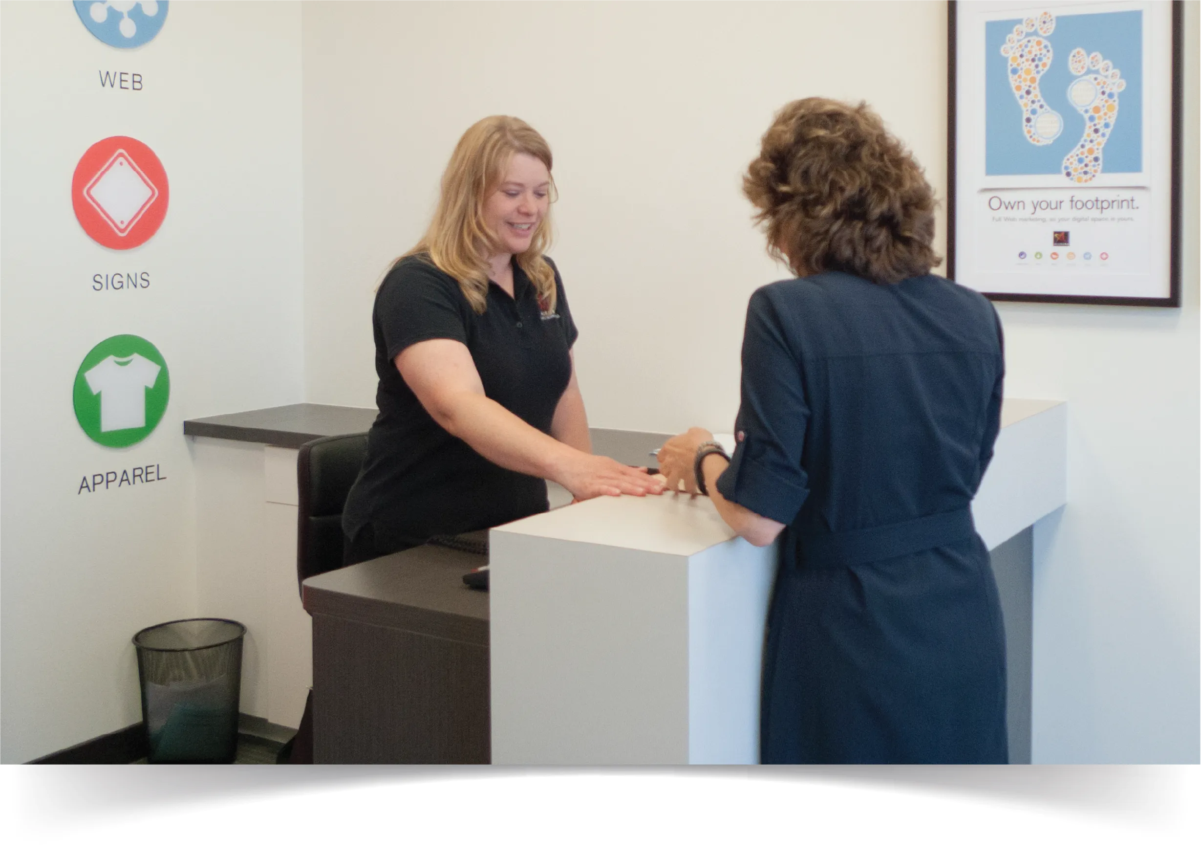 Allegra employee assisting a customer